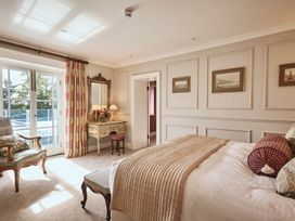 A bedroom with a bed and bedside table at Craig y Don in Glyngarth near Llandegfan