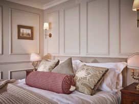 A bedroom with a bed and pillows at Craig y Don in Glyngarth near Llandegfan