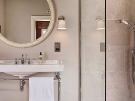 A bathroom with a sink and shower at Craig y Don in Glyngarth near Llandegfan