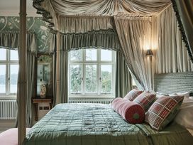 A bedroom with a bed and window at Craig y Don Glyngarth near Llandegfan