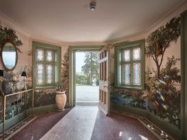 A hallway with a door and windows at Craig y Don in Glyngarth near Llandegfan