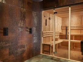 A spa area featuring a sauna with wooden benches at Craig y Don in Glyngarth near Llandegfan