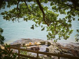 A seating area by water at Craig y Don in Glyngarth near Llandegfan