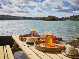 An outdoor table with drinks and hats at Craig y Don Glyngarth near Llandegfan