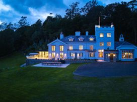 A house with a patio and seating area at Craig y Don in Glyngarth near Llandegfan