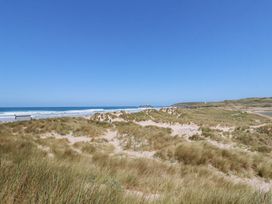 A beach with sand dunes and ocean view at Bramble Cottage in Gwithian near Connor Downs