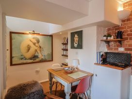 A study room with a desk and shelves at The Clock Tower Rousdon, Nr Lyme Regis