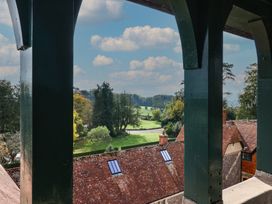 A view of a golf course and trees from a balcony at The Clock Tower in Rousdon, Nr Lyme Regis