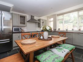 A kitchen with a dining table and chairs at Pear Tree Cottage Great Ouseburn