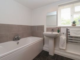 A bathroom with a bathtub and sink at Pear Tree Cottage in Great Ouseburn