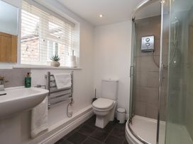 A bathroom with a sink and shower at Pear Tree Cottage in Great Ouseburn