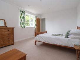 A bedroom with a bed and chest of drawers at Pear Tree Cottage Great Ouseburn