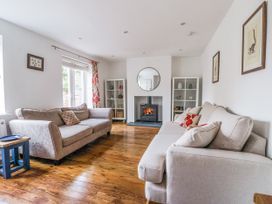 A living room with two sofas and a fireplace at Pear Tree Cottage in Great Ouseburn
