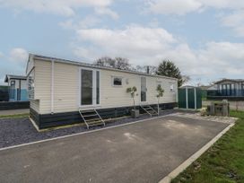 A mobile home with steps leading to two entrances and a small shed beside it at Dunlin Walk 13 Hayling Island