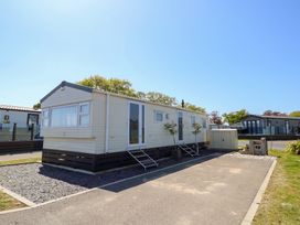 A mobile home with steps and planters at MillRythe Holiday Park (Dunlin Walk 13) Hayling Island