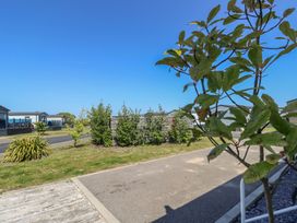 An outdoor view with houses and greenery at MillRythe Holiday Park (Dunlin Walk 13) Hayling Island