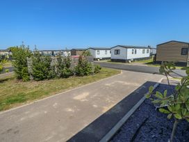 An outdoor area with caravans and a path at MillRythe Holiday Park (Dunlin Walk 13) Hayling Island