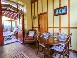 A dining room with a table and chairs at Maggie's Barn in Brecon
