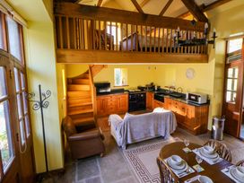 A kitchen with dining table and sofa at Maggie's Barn in Brecon