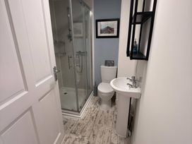 A bathroom featuring a shower, toilet, and sink at The Packing House in Rosudgeon