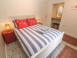 A bedroom with a bed and nightstand at The Packing House in Rosudgeon