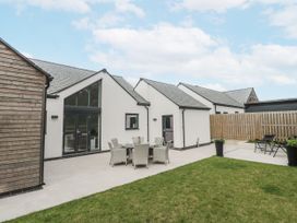 An outdoor area with seating and a patio at Kerrek Lodge in Mylor Bridge