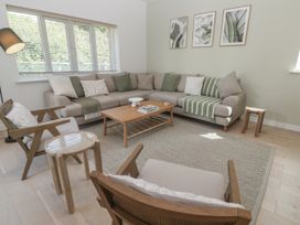 A living room with a sofa and coffee table at Kerrek Lodge in Mylor Bridge