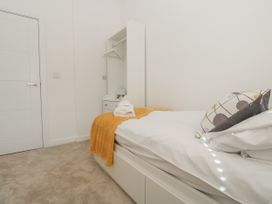 A bedroom with a bed and towels at Kerrek Lodge in Mylor Bridge