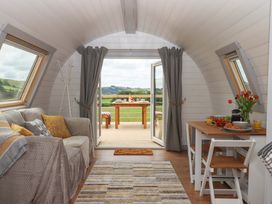 A living room with a sofa and table at Under Oak Pod in Totnes