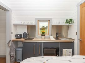 A kitchen area with sink and cupboard at Under Oak Pod Totnes