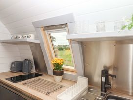 A kitchen with a sink and stove at Under Oak Pod in Totnes