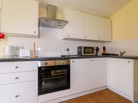 A kitchen with appliances and cabinets at H2 Atlantic Bay Holiday Park in Padstow