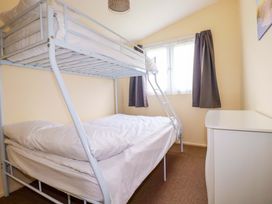 A bedroom with a bunk bed and a double bed at H2 Atlantic Bay Holiday Park Padstow