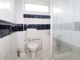 A bathroom with a toilet and shower at H2 Atlantic Bay Holiday Park, Padstow
