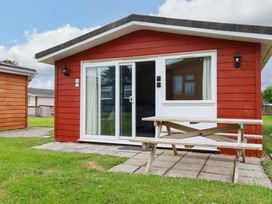 A cabin with a picnic table outside at H2 Atlantic Bay Holiday Park in Padstow