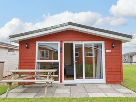 A cabin with a table and benches at 161 Atlantic Bay Holiday Park in Padstow
