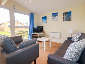 A living room with a sofa and coffee table at 161 Atlantic Bay Holiday Park in Padstow