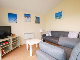 A living room with a television and sofas at 161 Atlantic Bay Holiday Park, Padstow