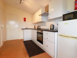 A kitchen with a fridge and oven at 161 Atlantic Bay Holiday Park in Padstow