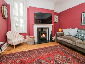 A living room with a fireplace and a sofa at Sunnycroft in Keswick