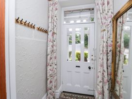 A hallway featuring a front door and coat hooks at Sunnycroft in Keswick