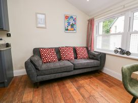 A living room with a sofa and paintings at Sunnycroft in Keswick