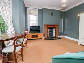 A living room with a television and fireplace at Sunnycroft in Keswick