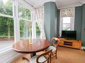 A living room with a table and a television at Sunnycroft in Keswick