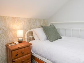 A bedroom with a bed and bedside table at Sunnycroft in Keswick