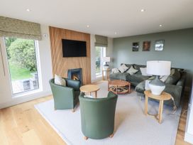 A living room with a sofa, armchairs, and a coffee table at Rowanhill in Kendal