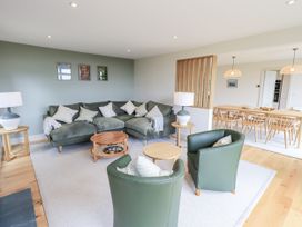 A living room with a sofa and dining area at Rowanhill in Kendal