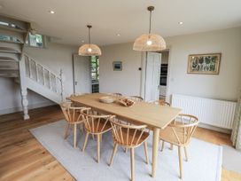 A dining room with a table and chairs at Rowanhill in Kendal