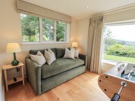 A snug with a sofa and foosball table at Rowanhill in Kendal