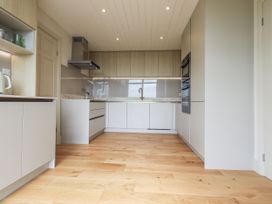 A kitchen with cabinets and appliances at Rowanhill in Kendal